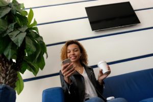 woman in office lobby with tv on wall